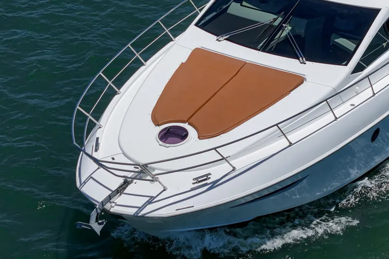 Slide: The Image of 2012 Azimut 48 yacht cruising on clear blue water, showcasing sleek design and luxury. - 8