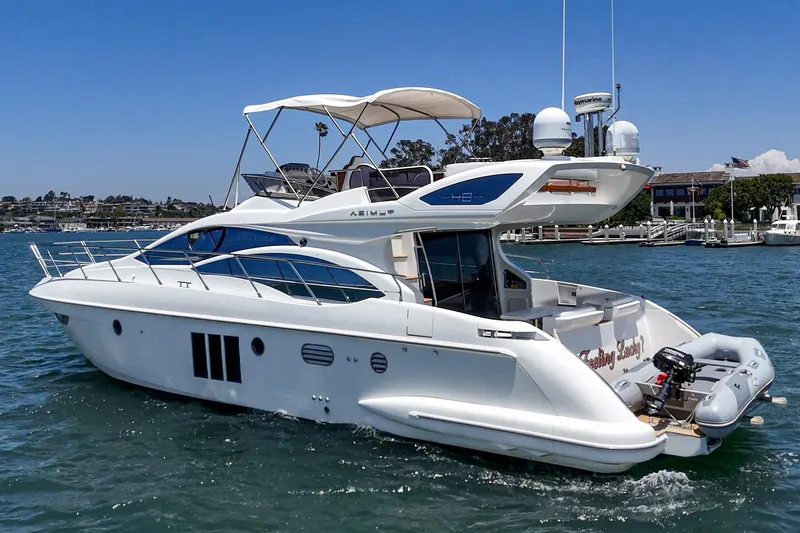 Slide: The Image of 2012 Azimut 48 yacht cruising on a sunny day near a marina. - 17