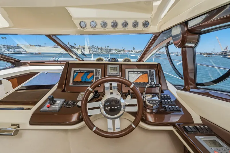 Slide: The Image of Luxurious 2012 Azimut 48 yacht helm with advanced navigation systems and scenic marina view. - 30