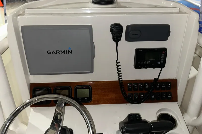 Slide: The Image of 2013 Jupiter 26 FS boat dashboard with Garmin navigation and communication equipment. - 4