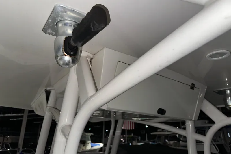 Slide: The Image of Close-up of a 2013 Jupiter 26 FS boat's T-top structure and mounted equipment. - 6