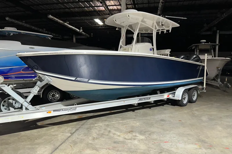 The Image of 2013 Jupiter 26 FS boat on trailer in indoor storage facility. - 1