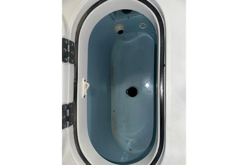 Slide: The Image of Livewell compartment of a 2013 Jupiter 26 FS boat, featuring a blue interior. - 7