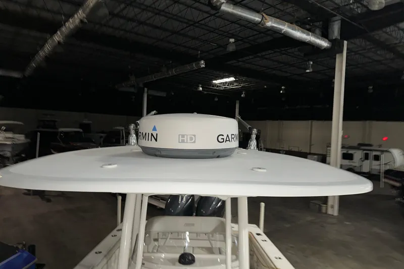Slide: The Image of 2013 Jupiter 26 FS boat with Garmin HD radar in a dimly lit warehouse. - 8