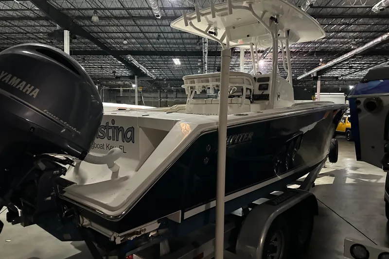 Slide: The Image of 2013 Jupiter 26 FS boat in warehouse, featuring Yamaha outboard motor. - 3