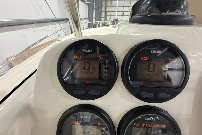 Slide: The Image of Yamaha gauges on a 2005 Pursuit 2670 Center Console boat dashboard. - 22