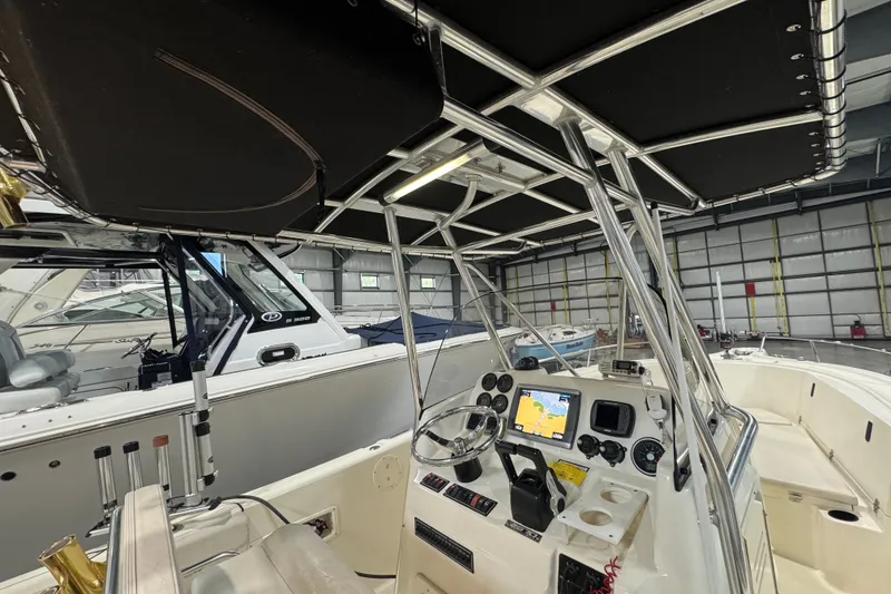 Slide: The Image of 2005 Pursuit 2670 Center Console boat interior with navigation equipment in a storage facility. - 31
