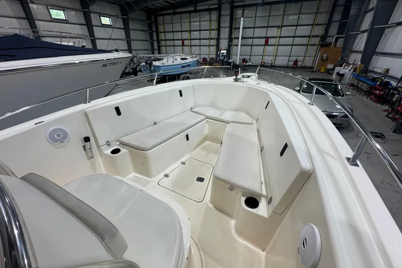 Slide: The Image of 2005 Pursuit 2670 Center Console boat interior with seating in a storage facility. - 32