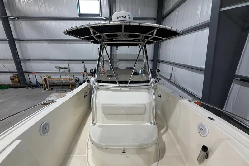 Slide: The Image of 2005 Pursuit 2670 Center Console boat in a storage facility, featuring a Garmin radar. - 14