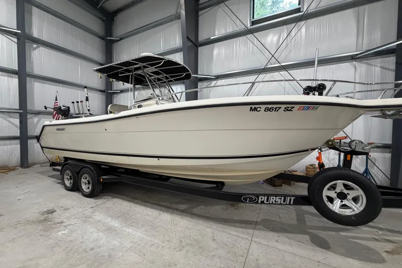The Image of 2005 Pursuit 2670 Center Console boat on trailer in storage facility. - 1