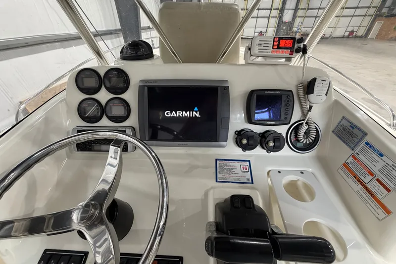 Slide: The Image of 2005 Pursuit 2670 Center Console dashboard with Garmin navigation and control instruments. - 20