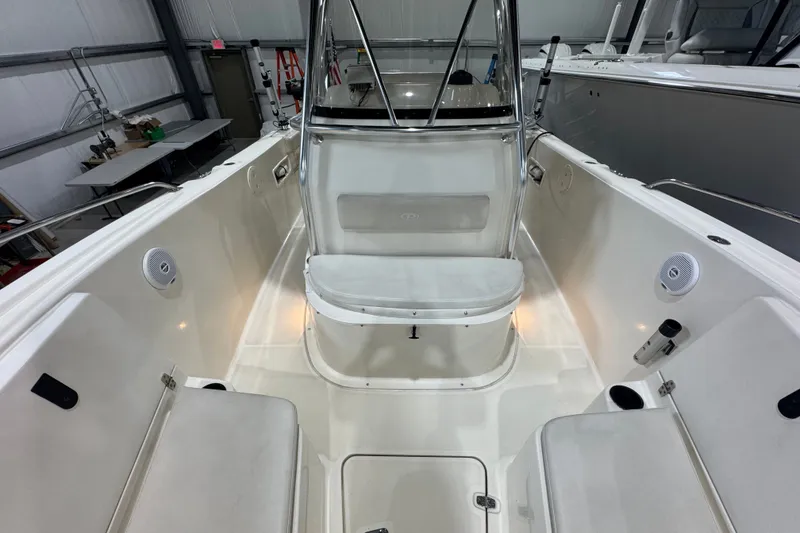 Slide: The Image of 2005 Pursuit 2670 Center Console boat interior with seating and console in a showroom. - 34