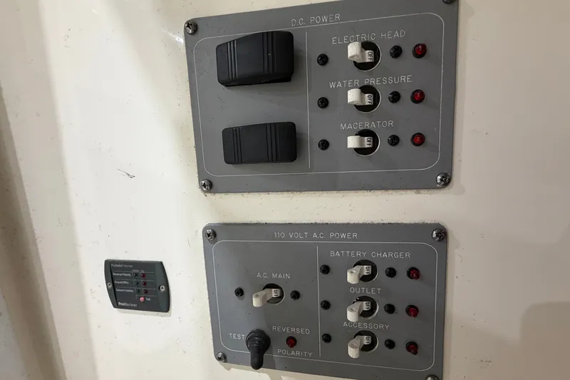 Slide: The Image of Control panel of a 2005 Pursuit 2670 Center Console boat, featuring DC and AC power switches. - 19