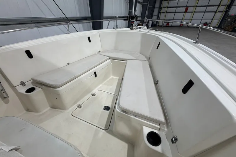 Slide: The Image of 2005 Pursuit 2670 Center Console boat interior with cushioned seating and storage compartments. - 23