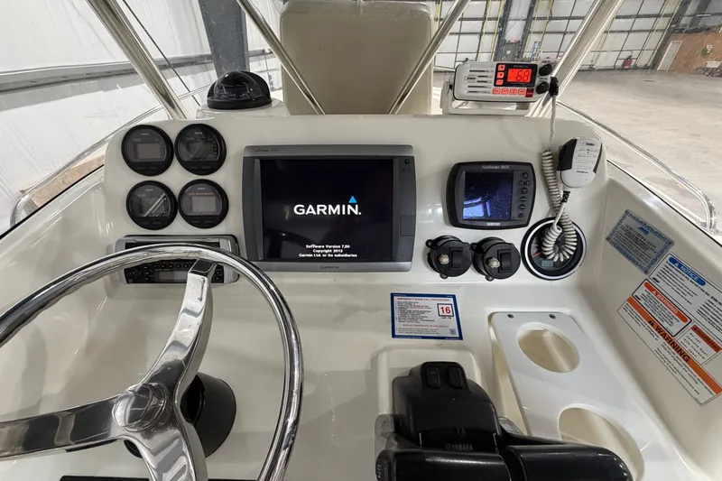 Slide: The Image of 2005 Pursuit 2670 Center Console dashboard with Garmin navigation and control instruments. - 21