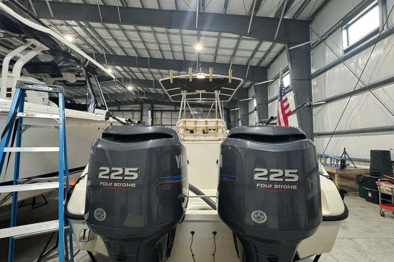 Slide: The Image of 2005 Pursuit 2670 Center Console boat with twin Yamaha 225 four-stroke engines in a garage. - 36