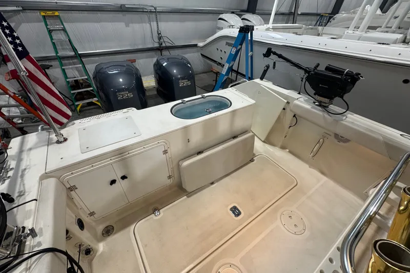 Slide: The Image of 2005 Pursuit 2670 Center Console boat interior with Yamaha 225 engines in a garage. - 27