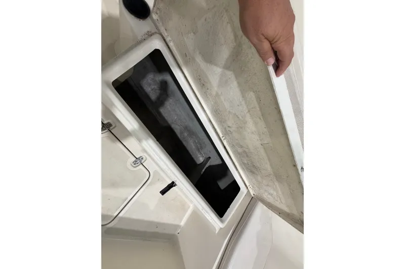 Slide: The Image of Open storage compartment on a 2005 Pursuit 2670 Center Console boat. - 17