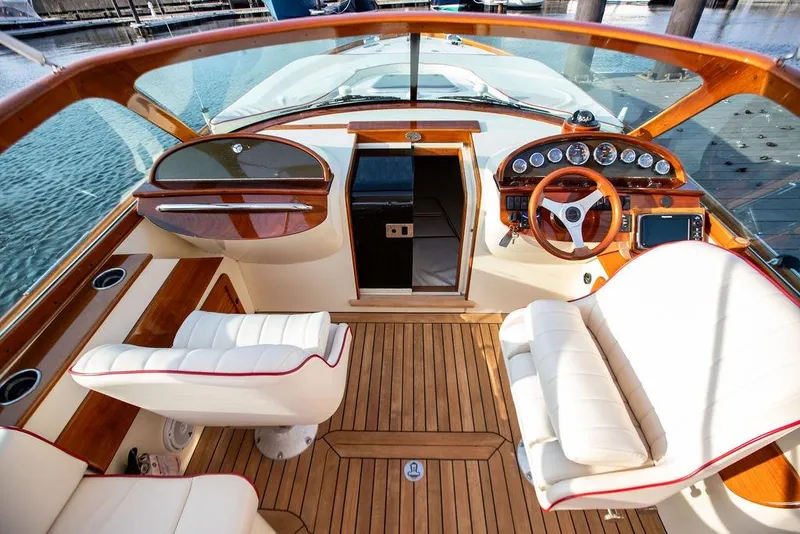Slide: The Image of 2008 Hinckley Talaria 29R cockpit with luxurious wood and leather interior design. - 2
