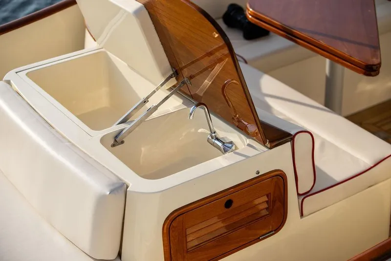 Slide: The Image of Luxury sink area on 2008 Hinckley Talaria 29R boat with wooden accents. - 18