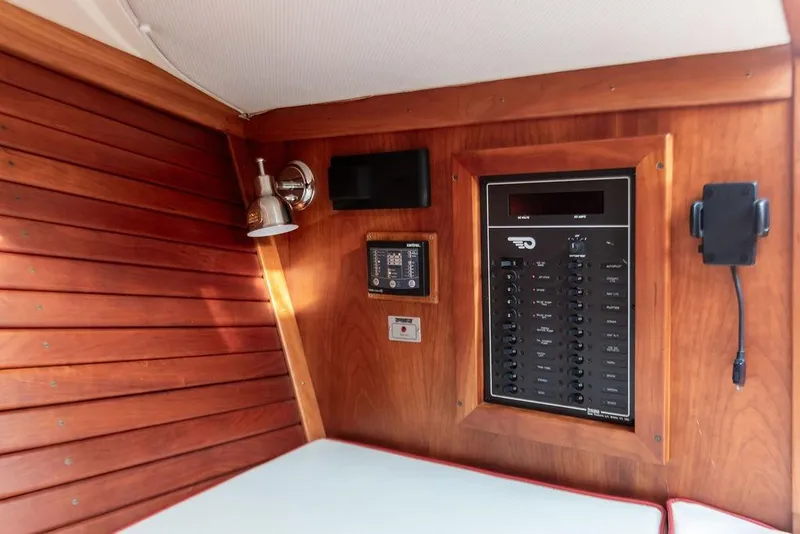 Slide: The Image of Hinckley Talaria 29R 2008 interior with wooden paneling and control panel. - 21