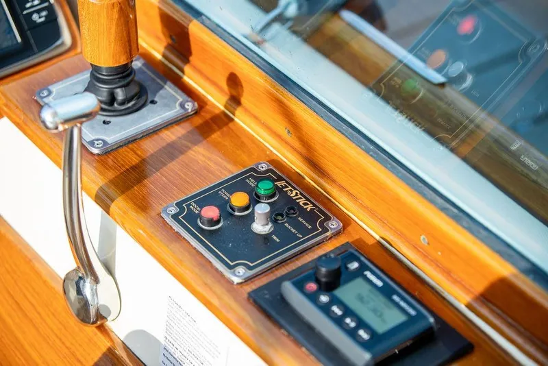 Slide: The Image of Control panel of a 2008 Hinckley Talaria 29R boat with joystick and buttons. - 11