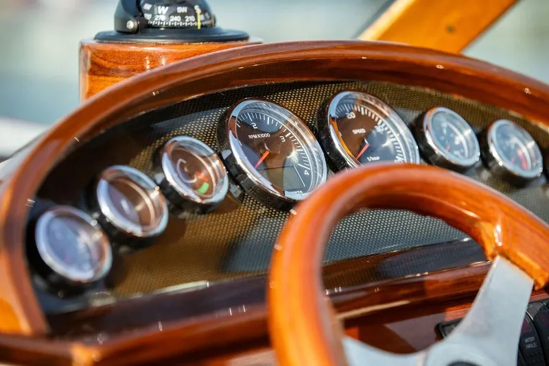 Slide: The Image of Dashboard of a 2008 Hinckley Talaria 29R boat with wooden steering wheel and gauges. - 7