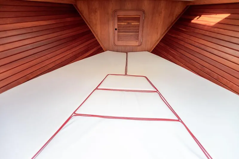 Slide: The Image of Interior cabin of 2008 Hinckley Talaria 29R with wooden paneling and cushioned bedding. - 20