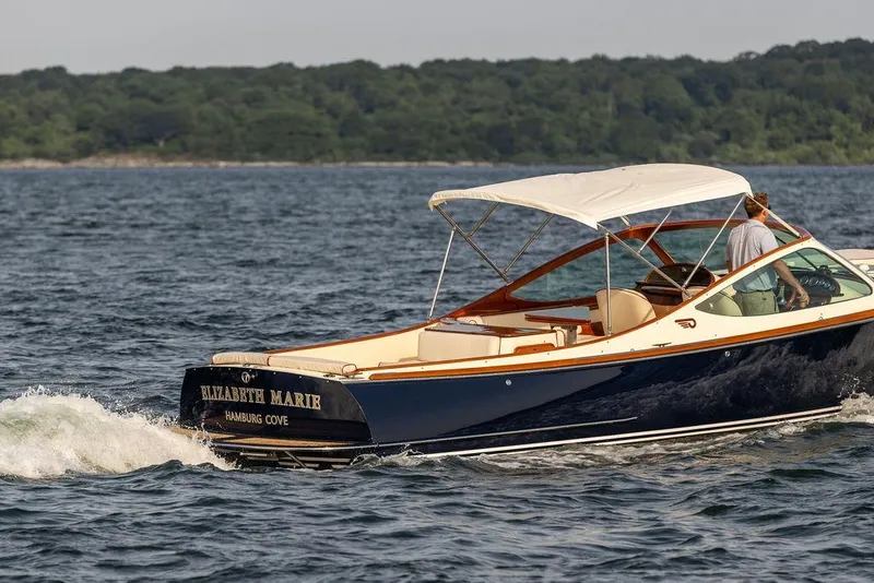 Slide: The Image of 2008 Hinckley Talaria 29R cruising on water with canopy, named "Elizabeth Marie." - 27