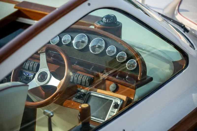 Slide: The Image of Interior view of 2008 Hinckley Talaria 29R boat dashboard with wooden steering wheel. - 9