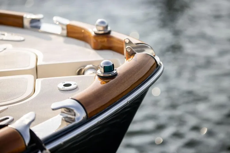 Slide: The Image of Close-up of 2008 Hinckley Talaria 29R boat's polished wooden and metal details by the water. - 25