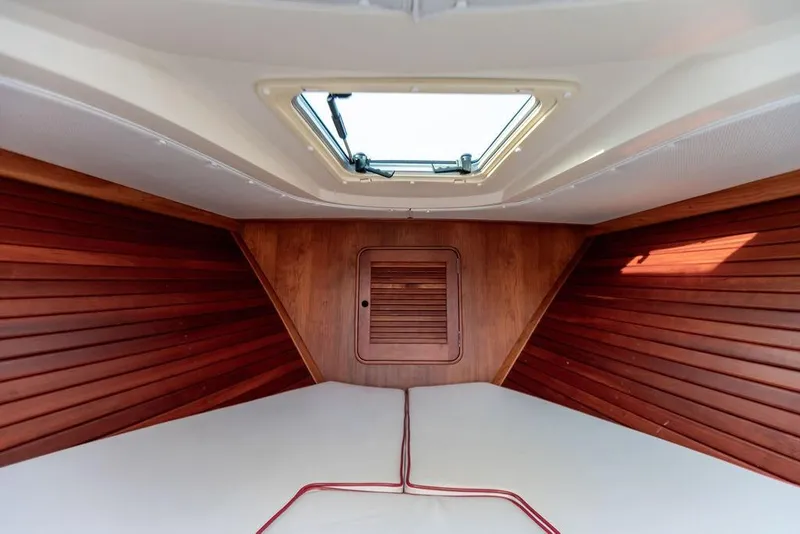 Slide: The Image of Interior cabin of 2008 Hinckley Talaria 29R with wooden paneling and skylight. - 3