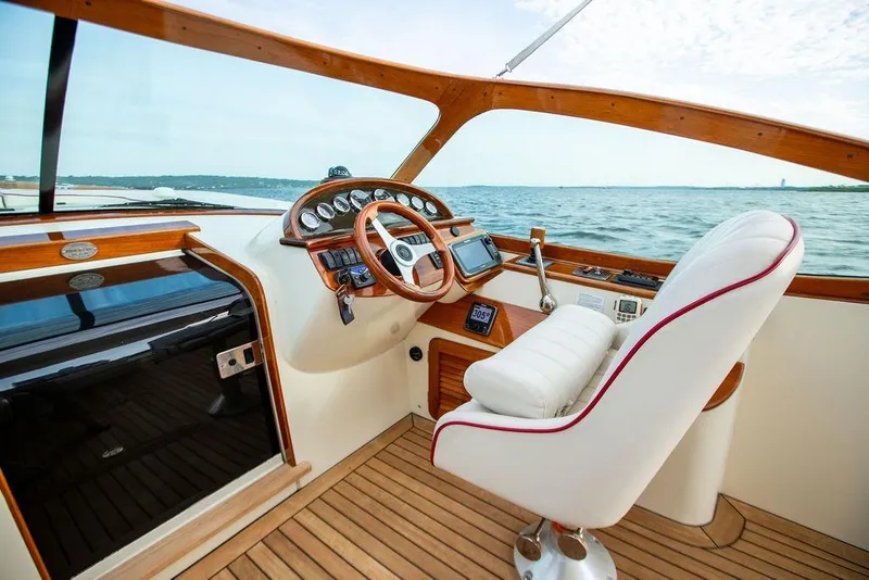 Slide: The Image of Helm of 2008 Hinckley Talaria 29R yacht with wooden accents and white captain's chair. - 12