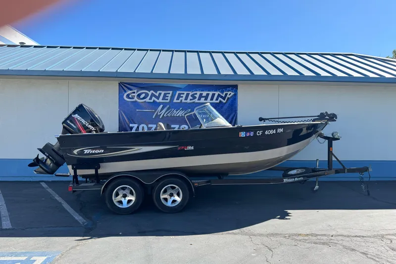 Slide: The Image of 2005 Triton DV 186 Mag boat on trailer, parked outside Gone Fishin' Marine. - 1