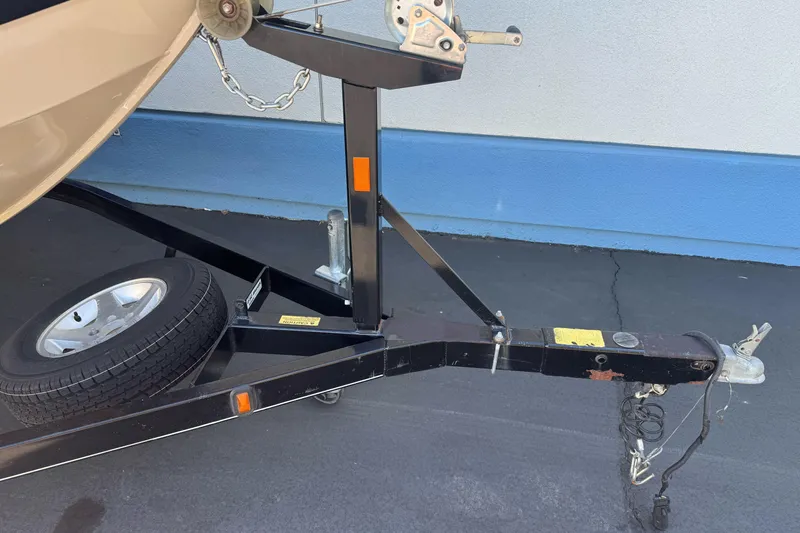 Slide: The Image of Trailer hitch of a 2005 Triton DV 186 Mag boat, parked on pavement. - 6