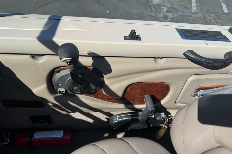 Slide: The Image of Interior of a 2005 Triton DV 186 Mag boat with control lever and fire extinguisher. - 17
