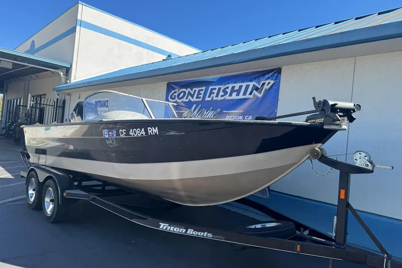 Slide: The Image of 2005 Triton DV 186 Mag boat on trailer outside marine shop. - 5