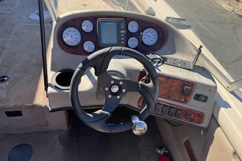 Slide: The Image of 2005 Triton DV 186 Mag boat dashboard with steering wheel and gauges. - 16
