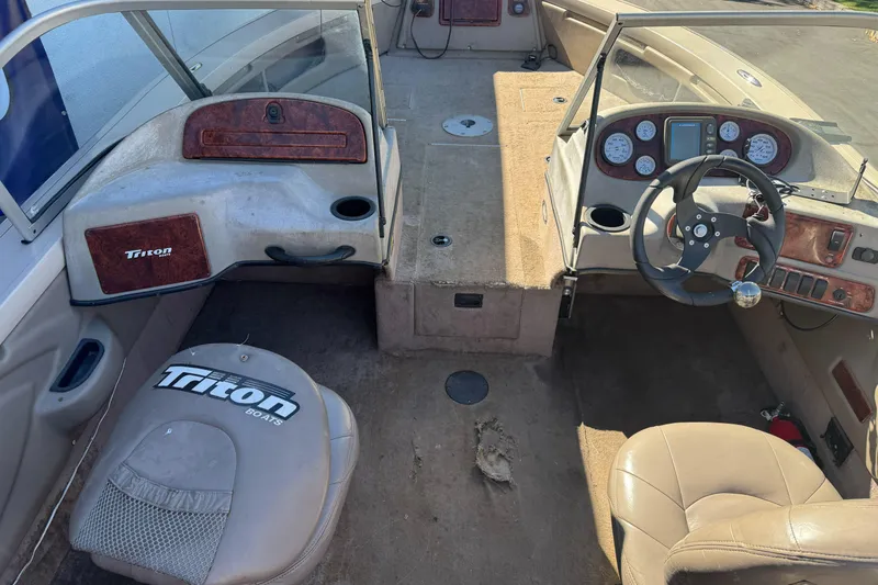 Slide: The Image of 2005 Triton DV 186 Mag boat interior with steering wheel and dashboard controls. - 18