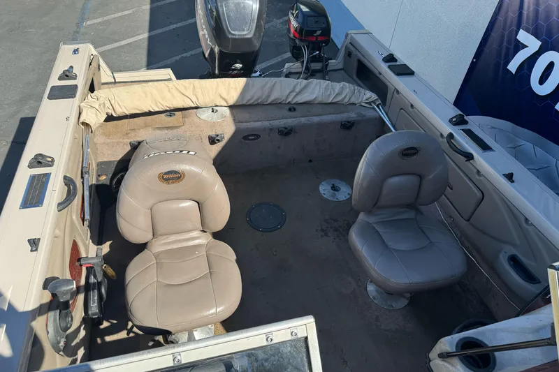 Slide: The Image of 2005 Triton DV 186 Mag boat interior with two beige seats and motor. - 12