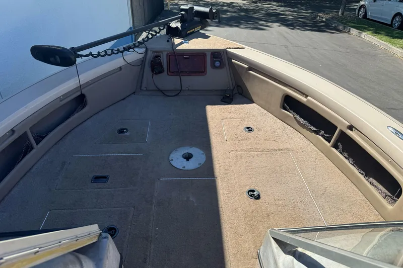 Slide: The Image of 2005 Triton DV 186 Mag boat interior with carpeted deck and storage compartments. - 9