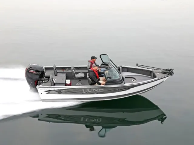 Slide: The Image of A 2020 Lund 1875 Impact XS Sport boat speeding across calm water. - 1