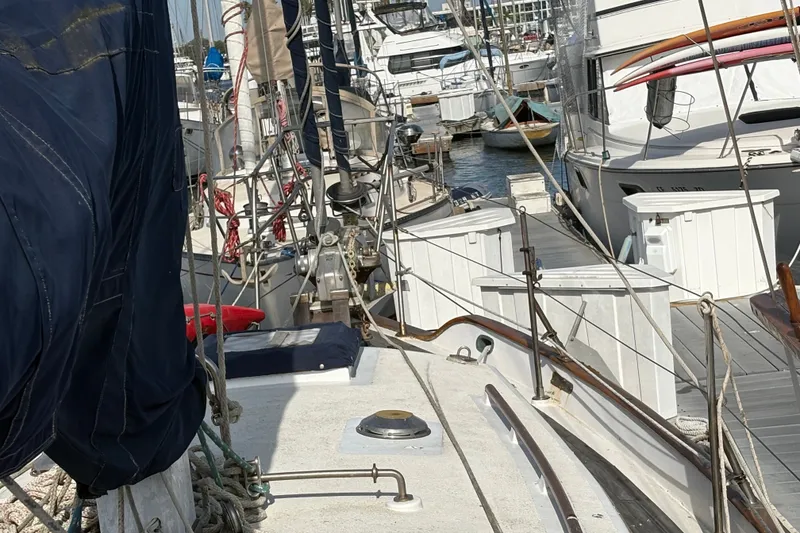 Slide: The Image of 1977 Tayana 37 Cutter sailboat docked in a busy marina. - 13
