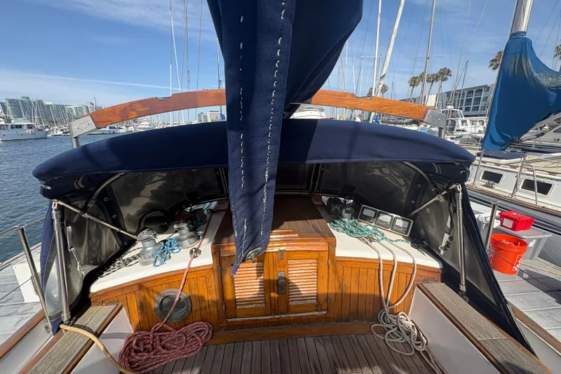 Slide: The Image of 1977 Tayana 37 Cutter sailboat cockpit with wooden details and nautical equipment. - 15