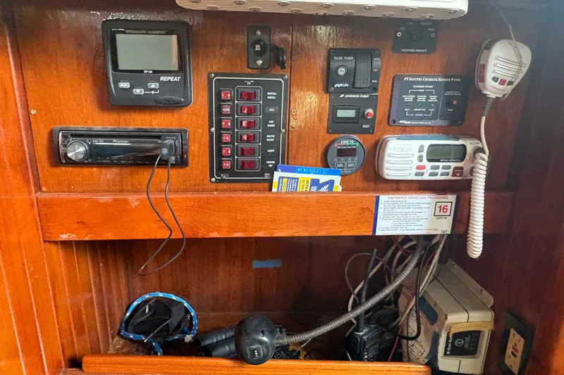 Slide: The Image of Control panel of a 1977 Tayana 37 Cutter sailboat with navigation and communication equipment. - 4
