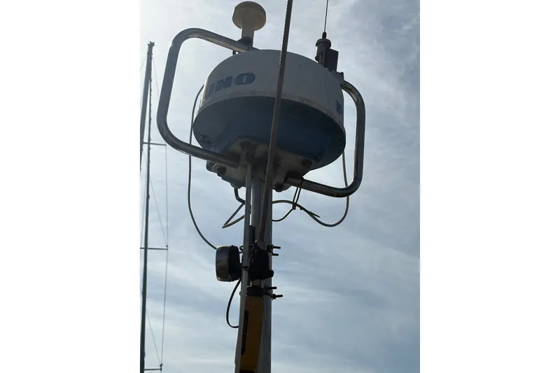Slide: The Image of Radar equipment on a 1977 Tayana 37 Cutter sailboat against a cloudy sky. - 18