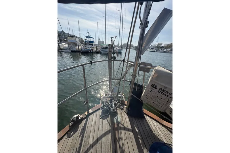 Slide: The Image of Sailing deck view of 1977 Tayana 37 Cutter in marina, with rescue equipment visible. - 20