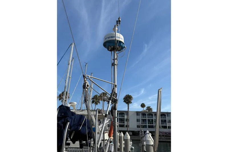 Slide: The Image of Mast of 1977 Tayana 37 Cutter sailboat with clear blue sky background. - 7