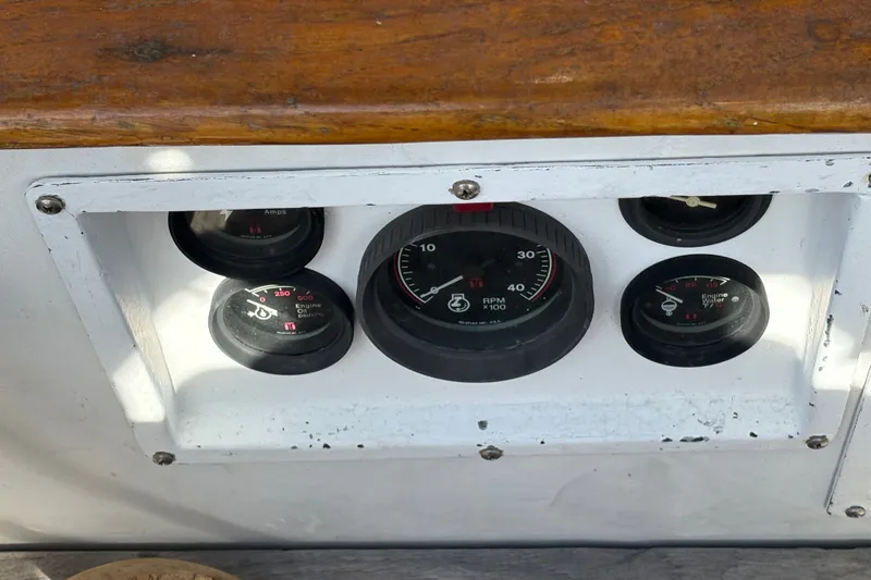 Slide: The Image of Instrument panel of a 1977 Tayana 37 Cutter sailboat, featuring multiple gauges. - 19