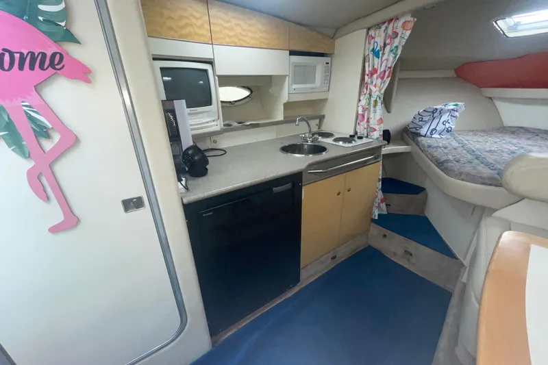 Slide: The Image of Interior of a 1999 Formula 31 Performance Cruiser with kitchenette and cozy sleeping area. - 27